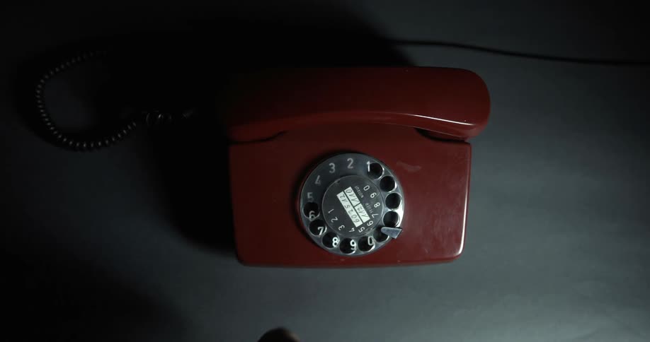 A person turns the dial on a phone