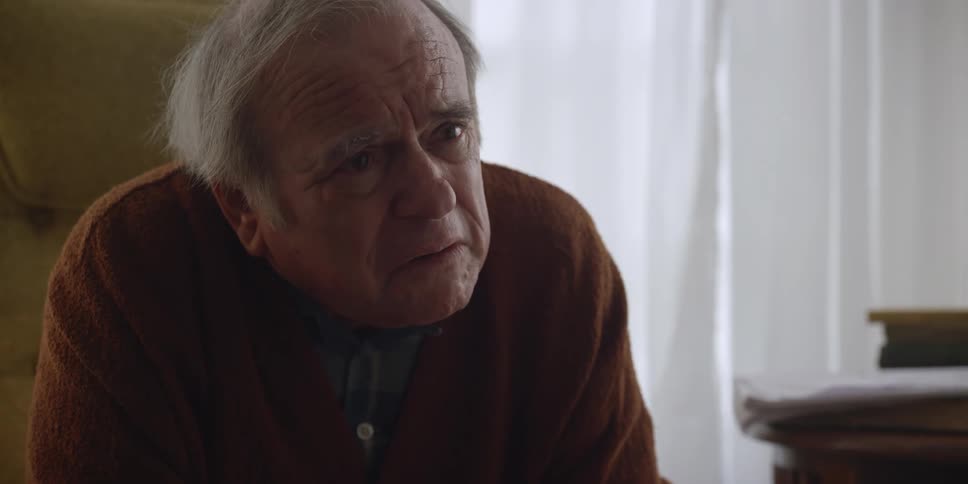 An elderly man is yelling at someone inside of his house