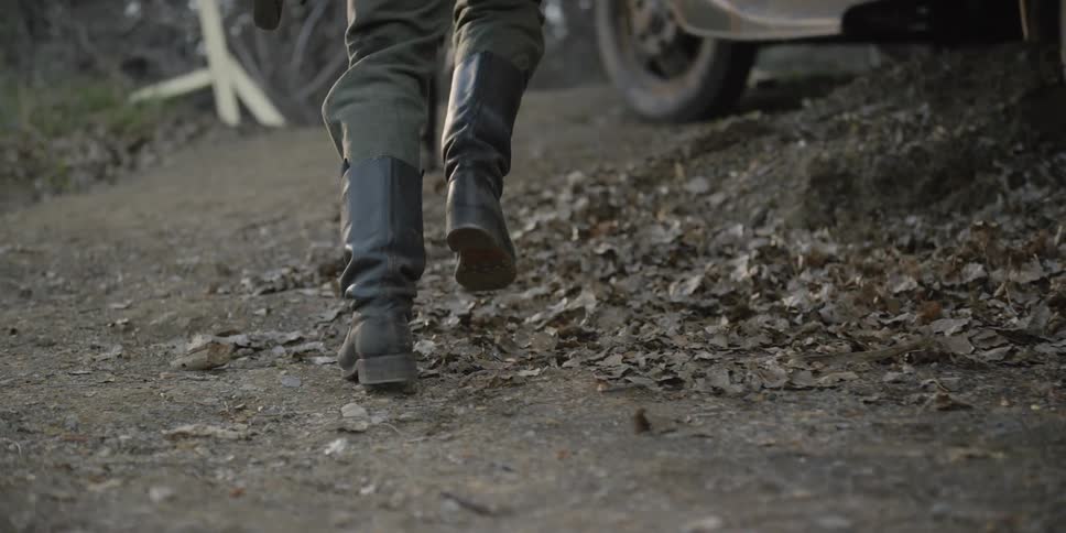 Soldiers in black boots jumping out of a parked vehicle and running away