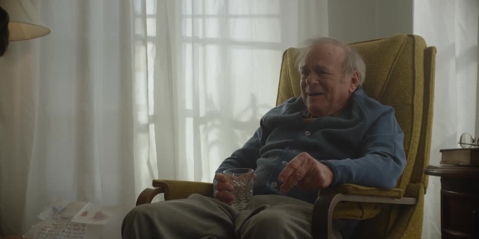 A man sobs while sitting in a chair