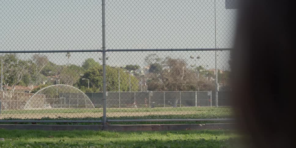 People are walking around the park in the distance