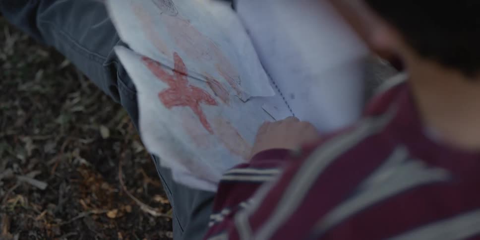 A child writes notes in his notebook