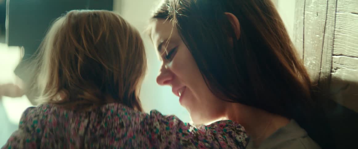 A mother holding her toddler daughter