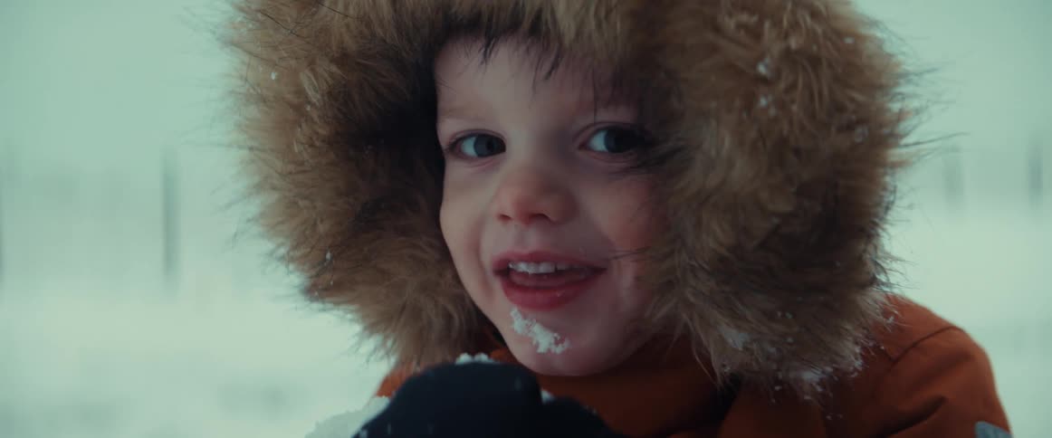 A child is tasting the snow