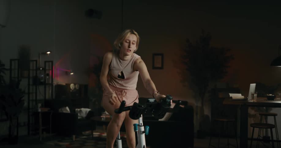 A young woman is working out inside of her home