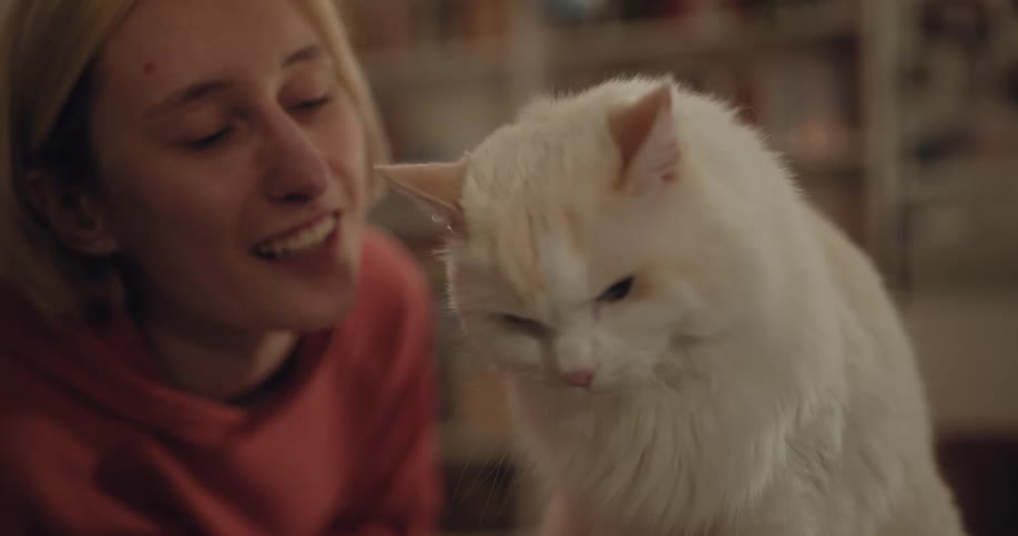A woman nuzzles her cats fur