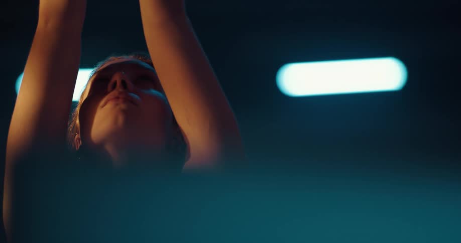 A woman stretching in a room