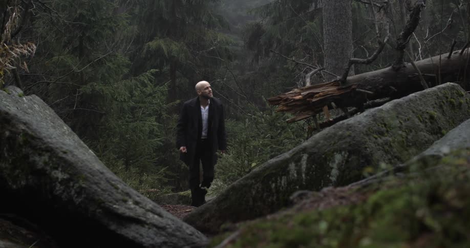 A man is climbing over rocks uphill
