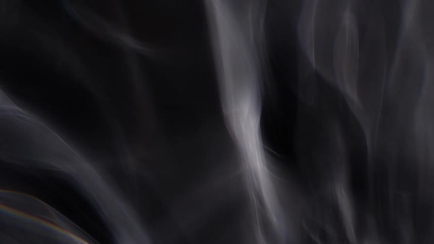 Thin gray layers float across as light brightens layers from black to light gray