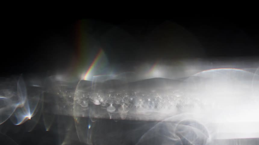 Smoke swirls around like a disk and wisps spiral off of it