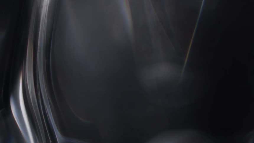 Light shines onto glossy surface causing it to shimmer