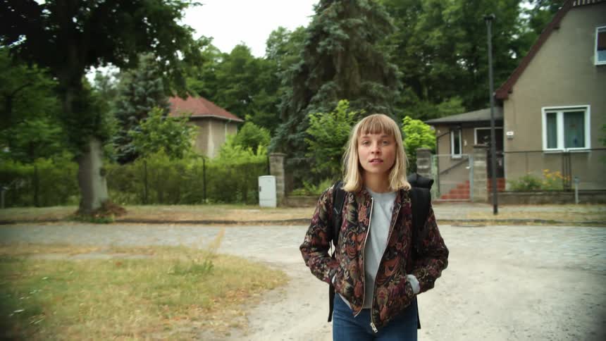 A woman walking around a neighborhood