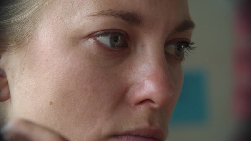 Close up of a woman lightin matches near her face