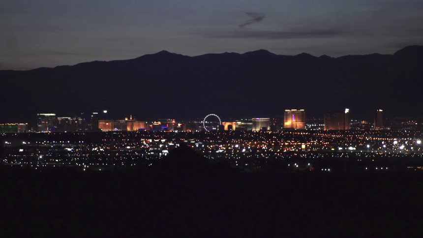 An illuminated city stands in the distance