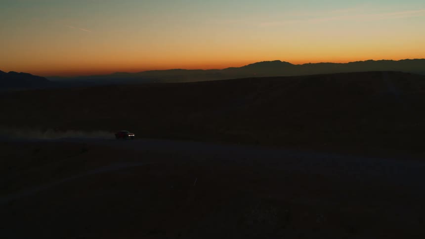 Baja Truck Races Across Frame At Sunset