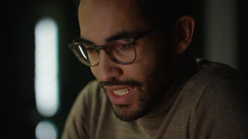 Man communicates on a video call smiling as he talks