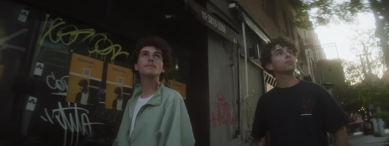 Two young men walking in a downtown area sightseeing