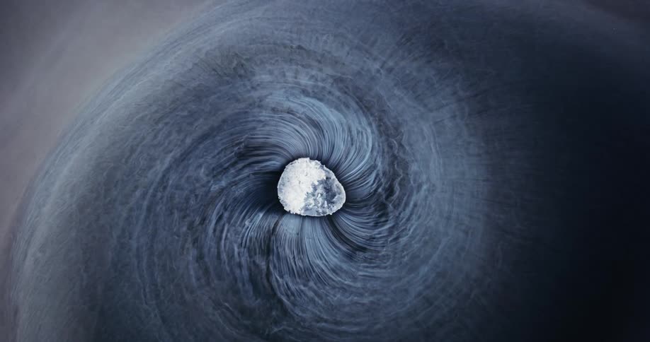 A rock spins in water