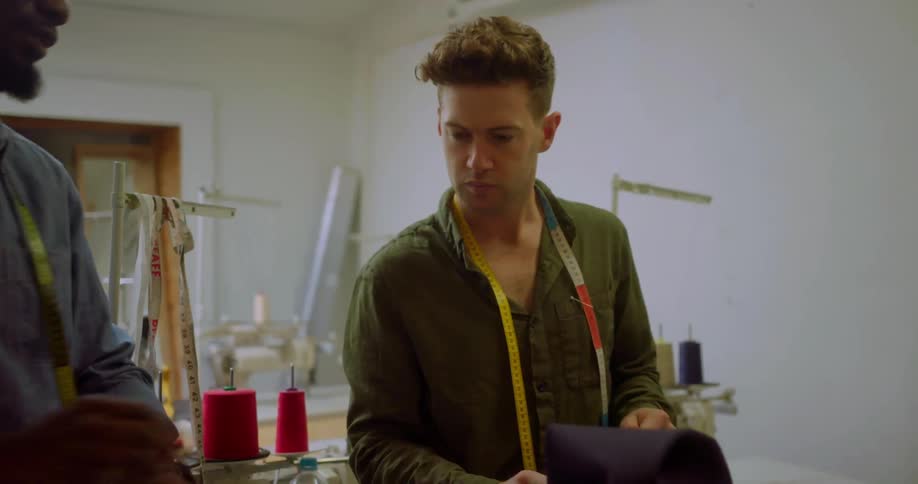 Two men work with fabric