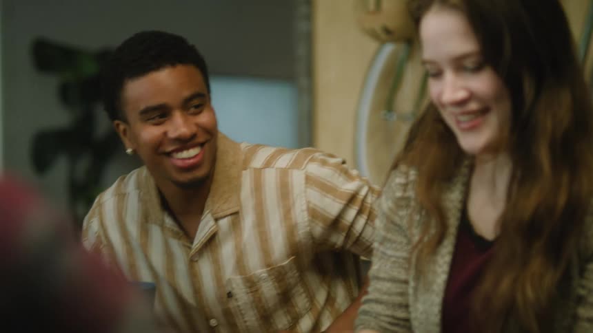 People playing with each other while holding cups and laughing