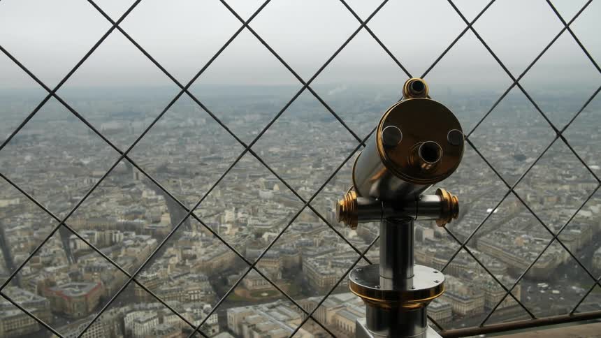 A telescope looks out over a city