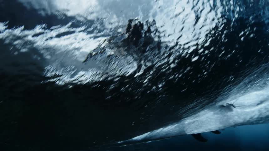 A surfer rides a strong wave