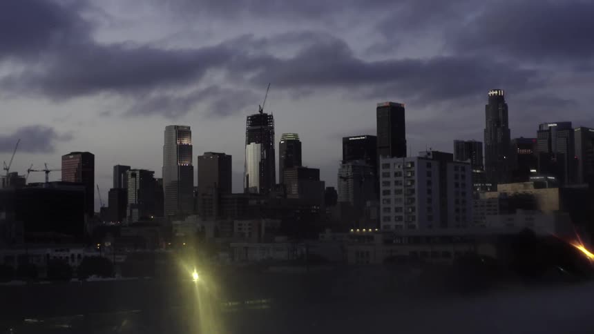 Clouds hovering over an urban skyline and harbor