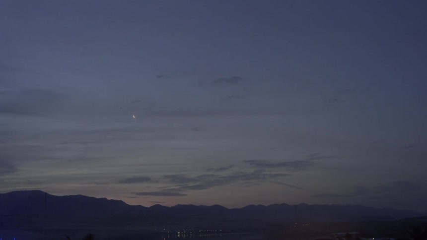 Clouds hovering over the mountains as night falls