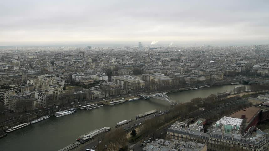 Traffic travelling next to a river on a cloudy day