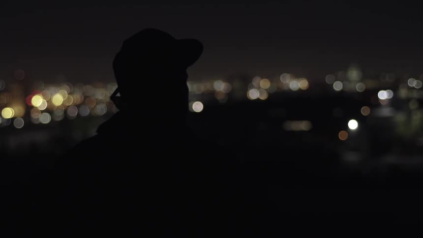 A man looks around at night