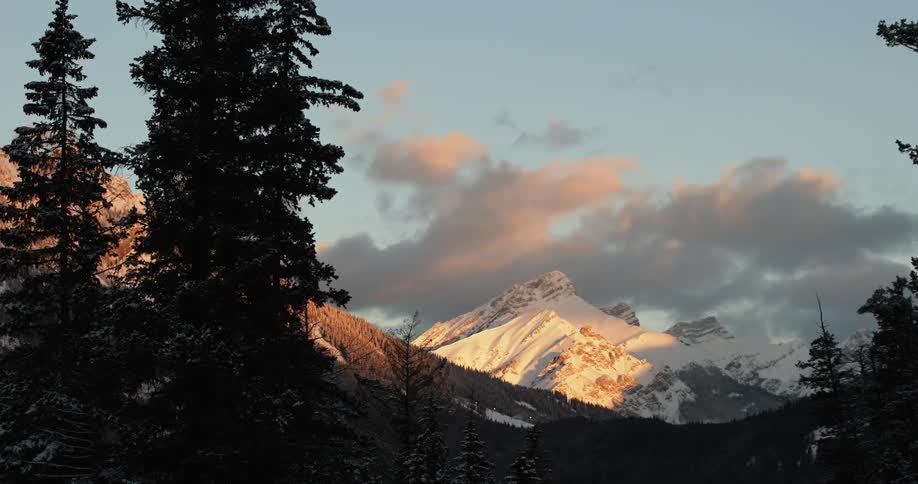 Landscape of clouds floating over snowy mountain