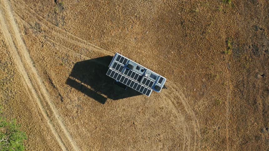 A structure with solar panels sitting in a remote area