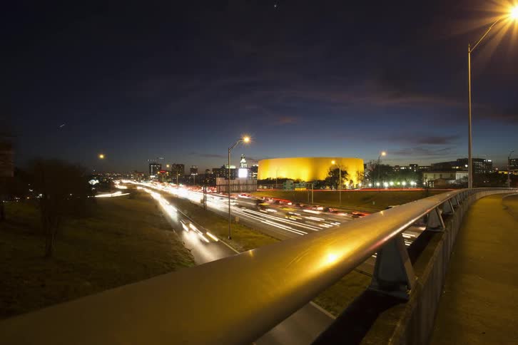 Traffic streaming along a highway as night falls