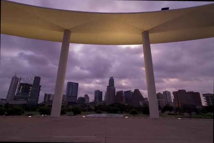 A city sits behind this stage as it lights up at night