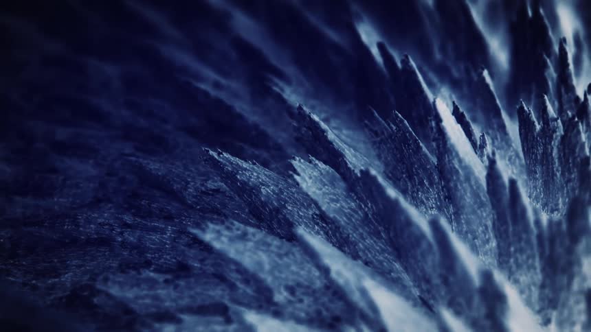 Textured blue and gray spikes move back and forth