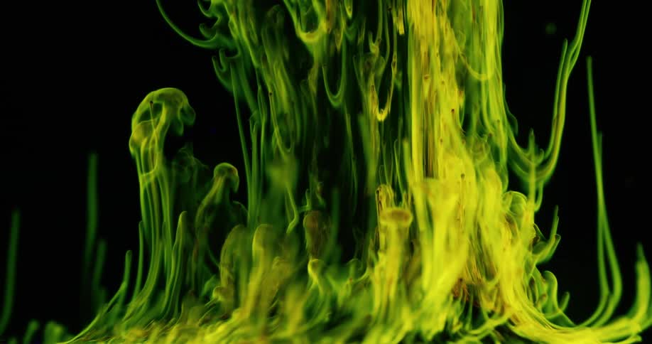 Green and yellow tendrils stretch before becoming gaseous against a black background dotted with blue