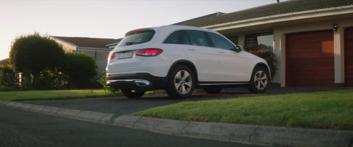 A car drives in front of the house