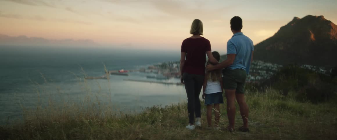 A family standing out near the sea