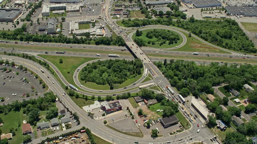 Aerial footage captures light traffic on a sunny day along a six-lane highway in Piscataway Township New Jersey