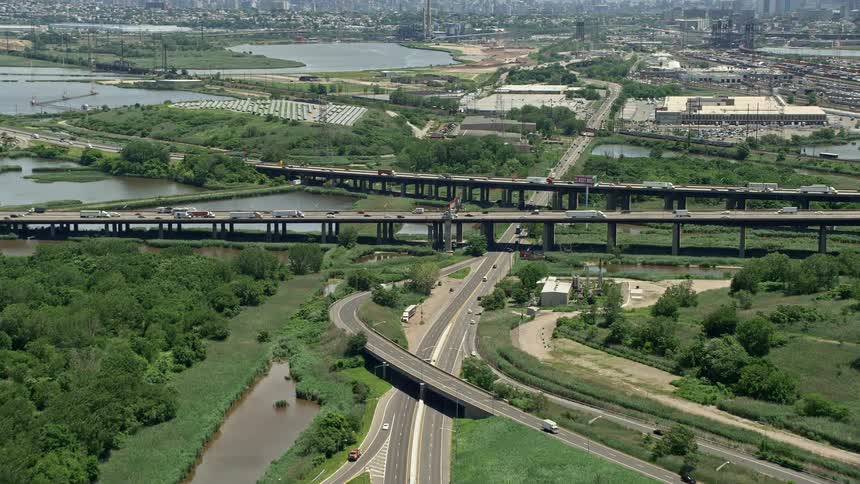 Aerial footage of heavy traffic approaching New Jersey Turnpike with sunshine and clear skies Kearny New Jersey