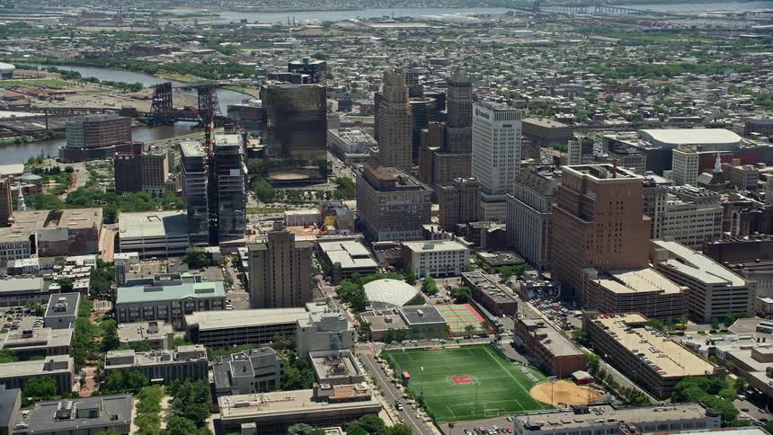 An aerial footage highlighting the downtown skyscrapers and high-rise buildings of Newark New Jersey during the summer