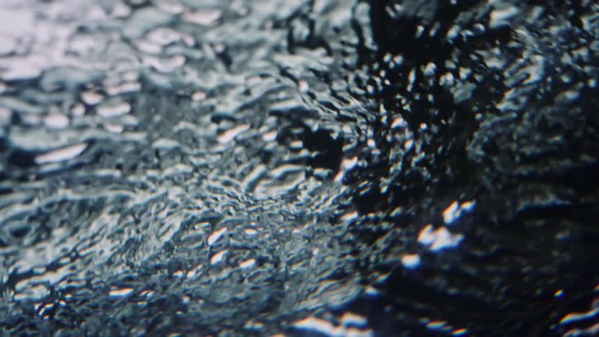 The surface of water rippling and flowing