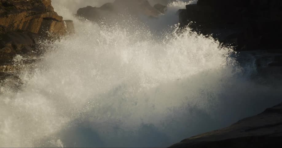 Water exploding towards camera as it descends from the glacier above