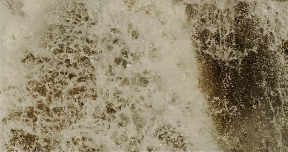 The water pours off the cliff as it falls into a million droplets in early morning light