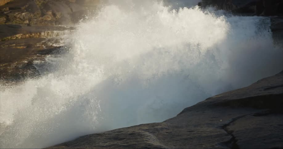 The camera follows water downstream as it explodes into smaller and smaller droplets as it crashes into the valley floor