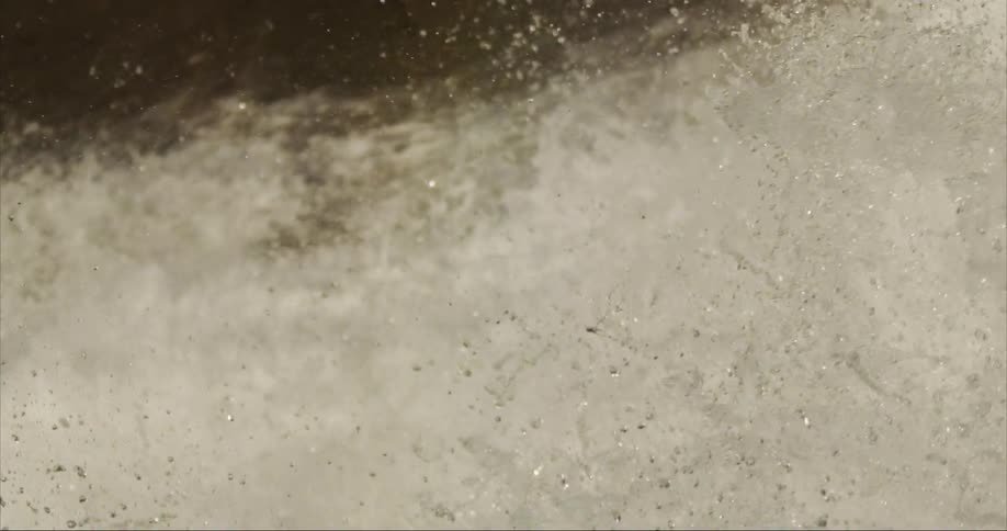 Slowmotion of water exploding down a massive alpine waterfall