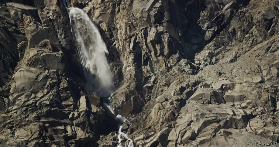 Landscape of waterfall cascading down the granite cliff face