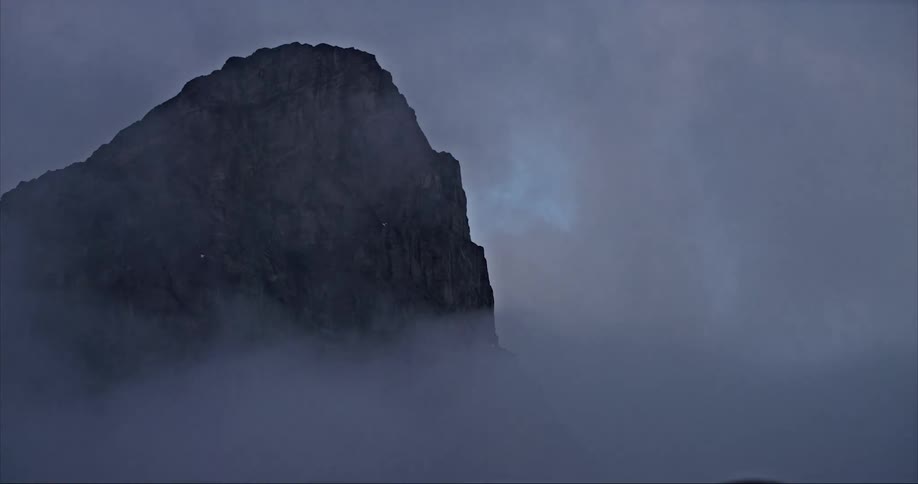 Storm clouds swirl around Mount Thor and the highest vertical drop in the world on Baffin Island
