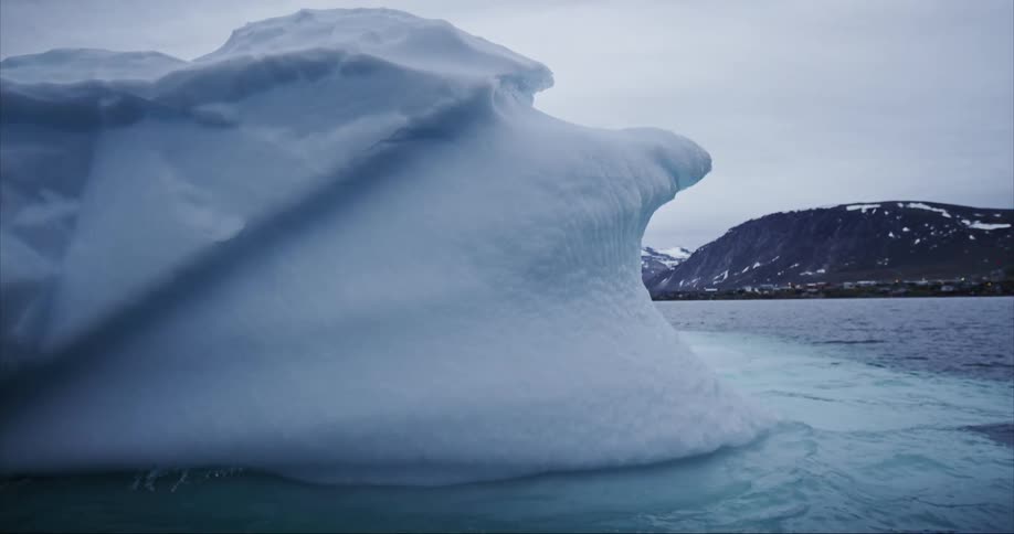The melting iceberg floats in seawater on Baffin Island in the arctic circle