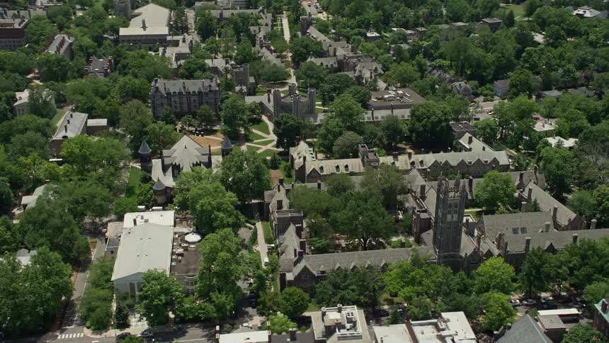 Aerial footage of Mathey College and Rockefeller College at Princeton University in New Jersey during daytime with sunshine and green trees